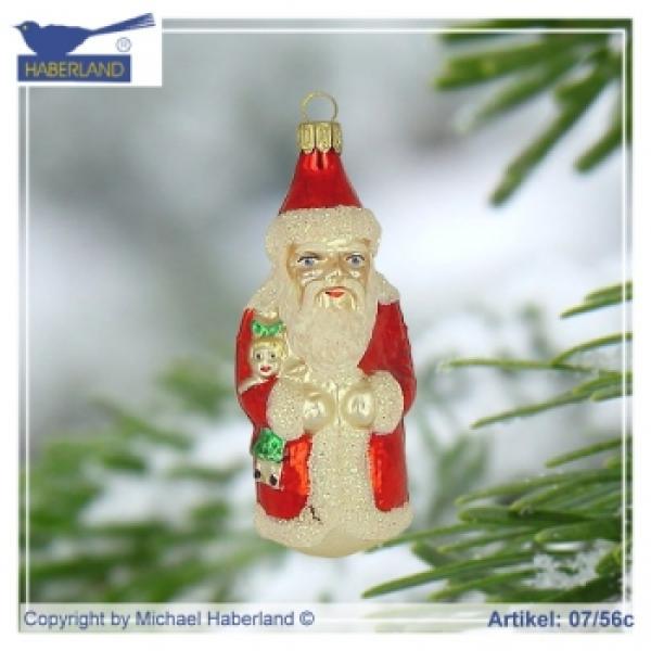 Kleiner Weihnachtsmann mit Puppe